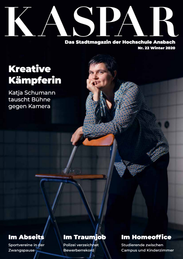 Kaspar Magazin Cover Ausgabe 22: Frau lehnt sich mit ihren Armen vor dunklem Hintergrund auf einen Stuhl